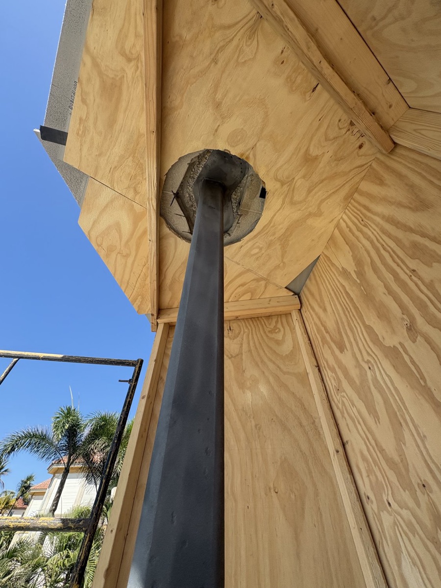 Steel structural column being sandblasted clean of paint and rust on-site